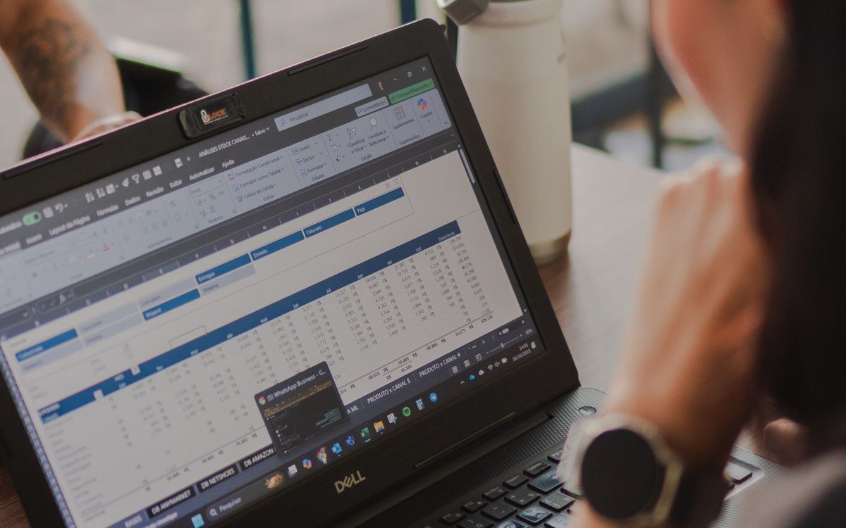 A billing spreadsheet of time entries open on a laptop