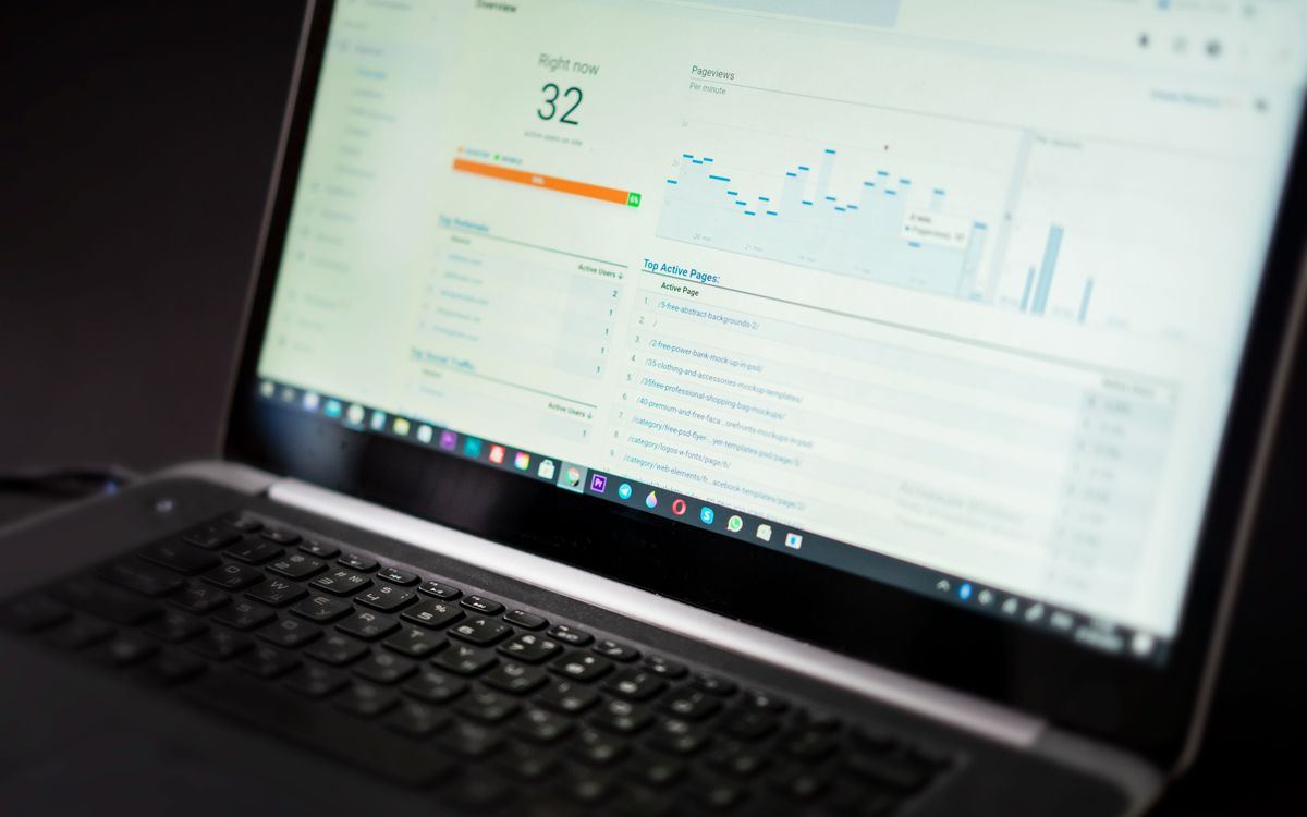 A laptop screen showing a live analytics overview with real-time data feeds